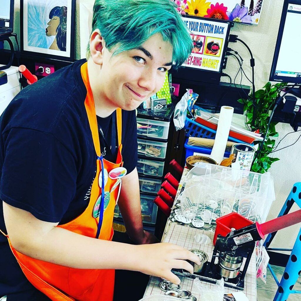 Intern working making buttons in the former Button Shoppe